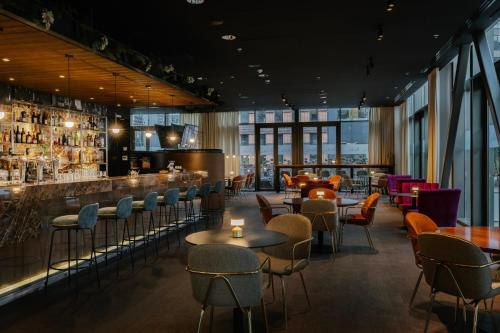 a restaurant with tables and chairs and a bar at Crowne Plaza Amsterdam - South by IHG in Amsterdam