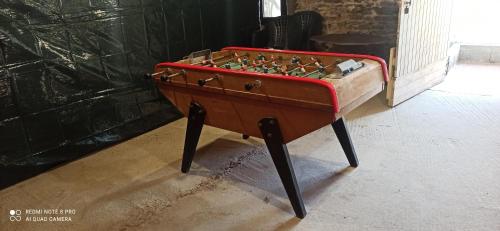 a foosball table sitting in a room at La Poserie des Monts et Vallées in Esson