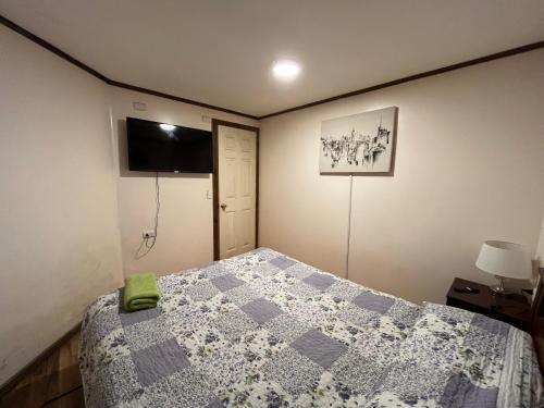 una camera con letto e TV a parete di Cabañas Francia a Osorno
