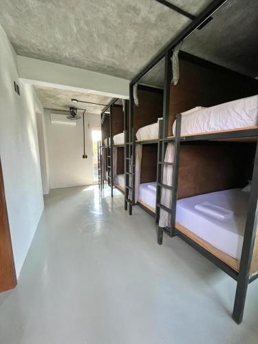 a room with several bunk beds in it at Straw Hat Surf Hostel & Bar in Brisas de Zicatela