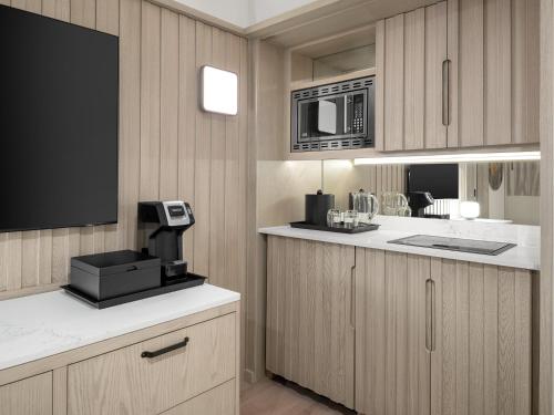 a kitchen with a microwave and a coffee maker on a counter at Grand Cayman Marriott Resort in George Town