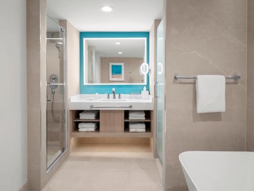 a bathroom with a sink and a mirror at Grand Cayman Marriott Resort in George Town