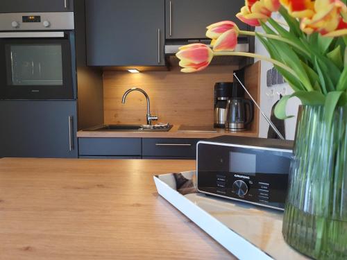 a kitchen with a vase of flowers on a table at Ferienwohnung Labskaus in Wittdün