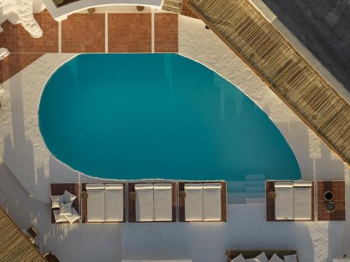 an overhead view of a swimming pool with a blue pool at Boheme Mykonos Town - Small Luxury Hotels of the World in Mikonos