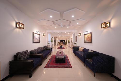 a large living room with couches and a table at Nights Inn Hotel in Islamabad