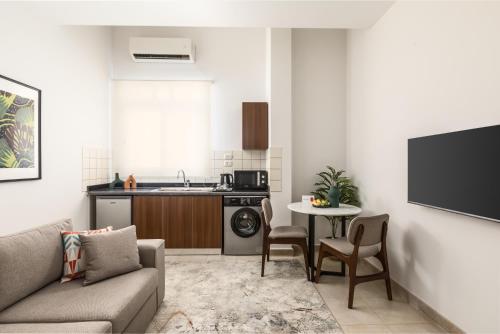 a living room with a couch and a table at Livingville The Two-Fifty in Cairo