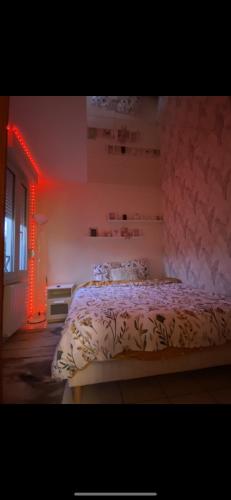 - une chambre avec un lit et une lumière rouge dans l'établissement Appartement jacuzzi, à Pontault-Combault
