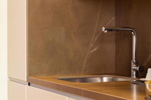 a kitchen sink with a faucet on a counter at Pescara INN Via Sulmona 17 in Pescara