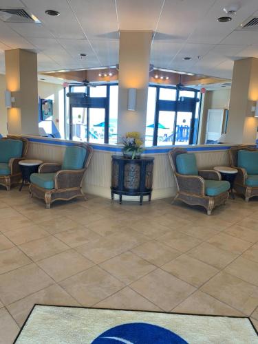 a waiting area in a hospital with chairs and a counter at Islander Beach Resort by CV in New Smyrna Beach
