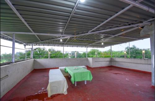 a large room with a green table in it at LAUGHTALE VILLA 4Bhk Swimming Pool in Lonavala