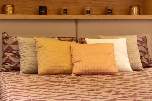 a group of pillows on a bed in a room at Pescara INN Via Sulmona 17 in Pescara