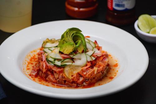a white plate of food on a table at Hotel Maioris El Diez Culiacan in Culiacán