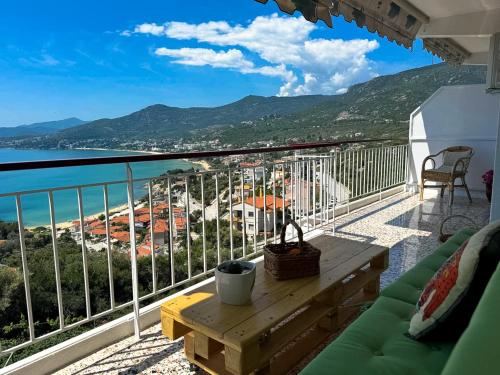a balcony with a table and a view of the ocean at Mimoza's Sea View Apartment in Paleo Tsifliki