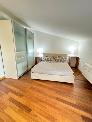 a bedroom with a bed and a wooden floor at Villetta Ginori - Private Spa in Grosseto