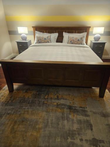 a large bed in a bedroom with two night stands at Ard Aoibhinn Roscommon Bed & Breakfast in Lecarrow