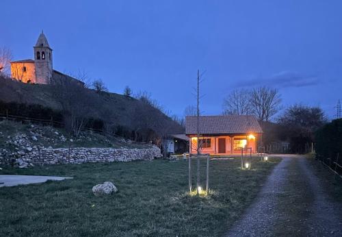a small house with lights in a field at night at Casa rural en Fontibre in Espinilla