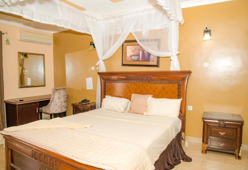 a bedroom with a large bed with a canopy at Tana Garden Hotel in Garissa
