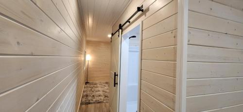 a hallway with wooden walls and a door at Beautiful Modern Shipping Container Cabin with Beautiful Views-Off the Grid in Waimea