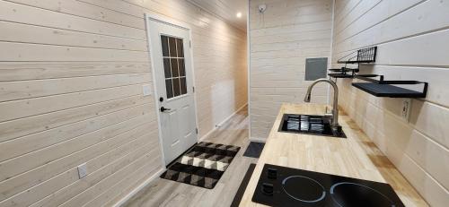 a bathroom with a sink and a counter with a sink at Beautiful Modern Shipping Container Cabin with Beautiful Views-Off the Grid in Waimea