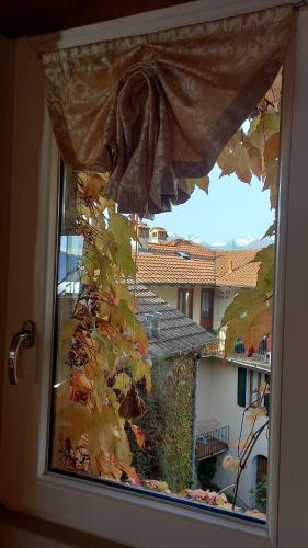 a window with a view of a house at La casa della Cindy in Dervio
