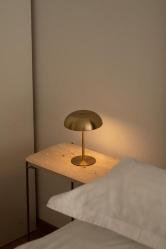 a small lamp on a table next to a bed at Adriatic Queen Residence in Split