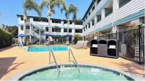 a swimming pool in front of a building at Heritage Inn San Diego in San Diego