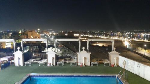 a view of a pool on top of a building at night at اعلاني in Luxor