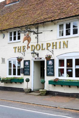 a white building with a dolphin sign on it at Hursley Rooms - The Dolphin in Winchester