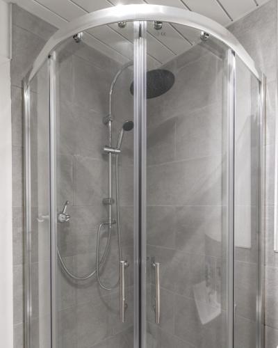 a shower with a glass door in a bathroom at Belfast Quarters: Modern City Centre Hub 3 Bed in Belfast