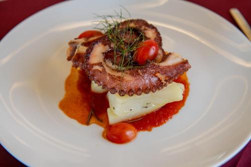 a white plate with a piece of food on it at Hacienda Samana Bay Hotel in Santa Bárbara de Samaná