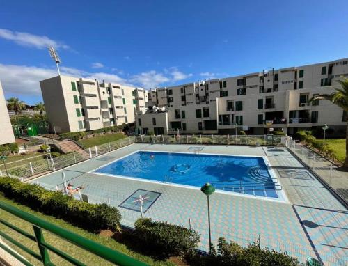 a large swimming pool in front of a building at Apartment Playa Las Americas in Playa de las Americas