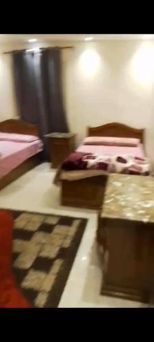 a blurry picture of a bedroom with two beds at Golden House in Alexandria