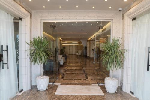 a hallway with two potted plants in a building at TK Royal & Spa in Hurghada