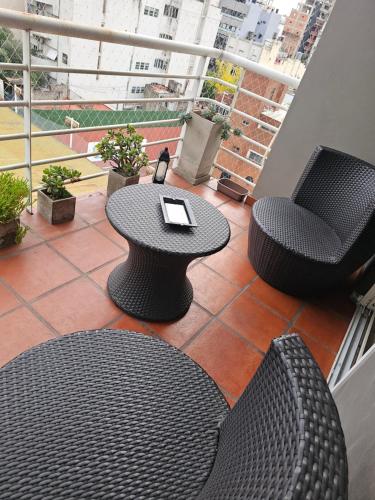 a balcony with a table and two chairs and a table at PALERMO APART 1 in Buenos Aires