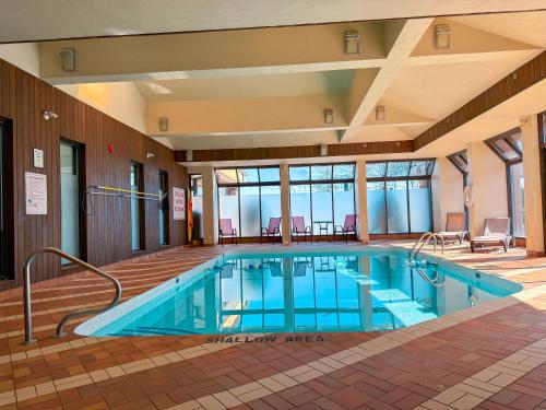 a large swimming pool in a hotel room at Ramada Plaza by Wyndham Niagara Falls in Niagara Falls