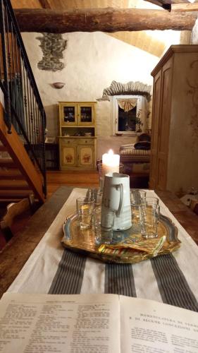 a table with a tea kettle and a book on it at La casa della Cindy in Dervio