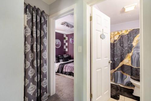 a hallway with a room with a bed in it at Elegant Serene Escape in Wyandotte in Wyandotte