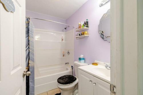 a white bathroom with a toilet and a sink at Elegant Serene Escape in Wyandotte 