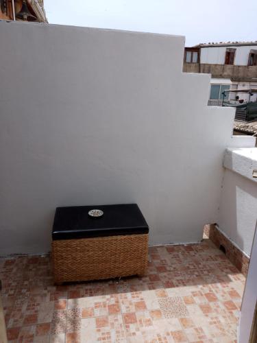 a box sitting in the corner of a white wall at Casa vacanze Emiliana in Ragusa