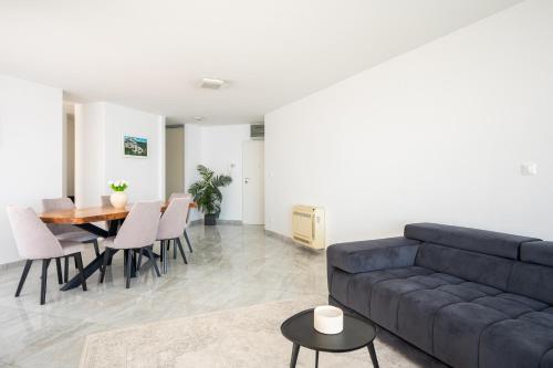 a living room with a couch and a table at Adriatic Queen Residence in Split