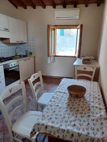a kitchen with a table and chairs and a table and a table and a kitchen at La casa gialla in Molino Mazzetti