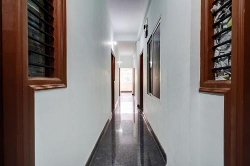 a corridor of a house with wine bottles at Super Hotel O PM Hotels in Bengaluru