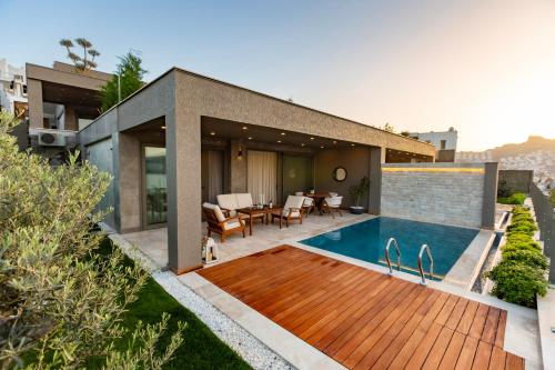 a house with a swimming pool in the backyard at Marje Villas Bodrum in Bodrum City