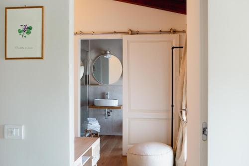 a bathroom with a door with a mirror at Agriturismo La Costa in Gropparello