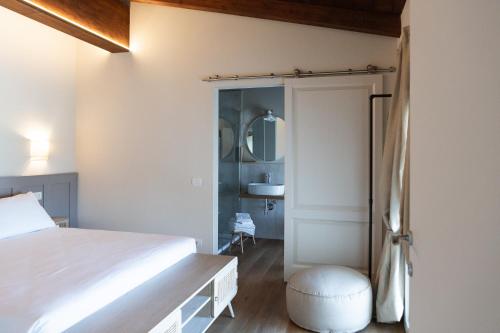 a bedroom with a bed and a bathroom at Agriturismo La Costa in Gropparello