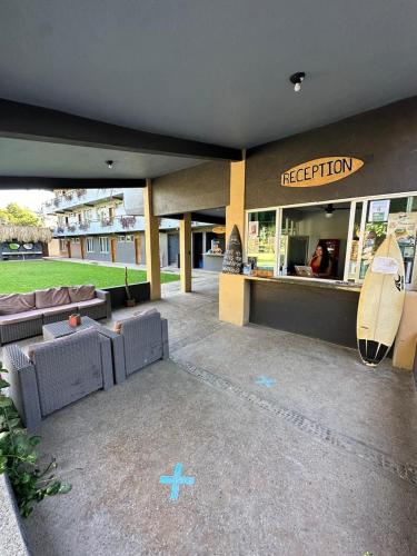 a hotel with a reception with a surfboard at Straw Hat Surf Hostel & Bar in Brisas de Zicatela