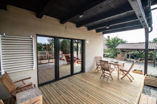 a patio with a table and chairs on a deck at Na Dubie in Zalewo