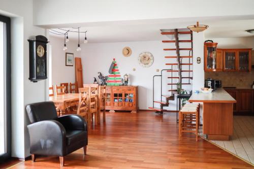 a living room and kitchen with a table and chairs at Na Dubie in Zalewo