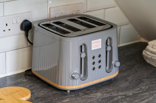 a toaster oven sitting on top of a counter at Modern 3 bedroom apartment in Wimbeldon Park in London