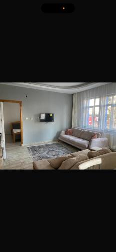 a living room with a large bed and a couch at MFC konaklama in Yeşilyurt